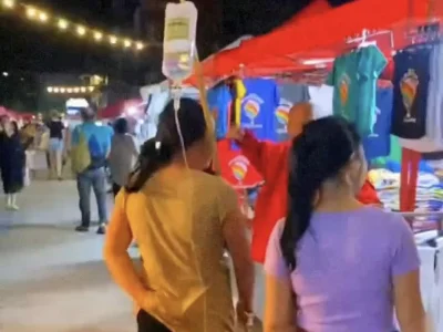 塔銮节太疯狂，患者跑出医院扛着吊瓶逛集市，网友：为了逛街连命都不要了？