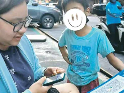 菲街童用二维码行乞引发热议